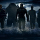 Concept art from The Suicide Squad featuring Peacemaker, King Shark, Bloodsport, Poke-Dot Man, and Harley Quinn in shadow walking in from the ocean to the shore with the moon behind them.